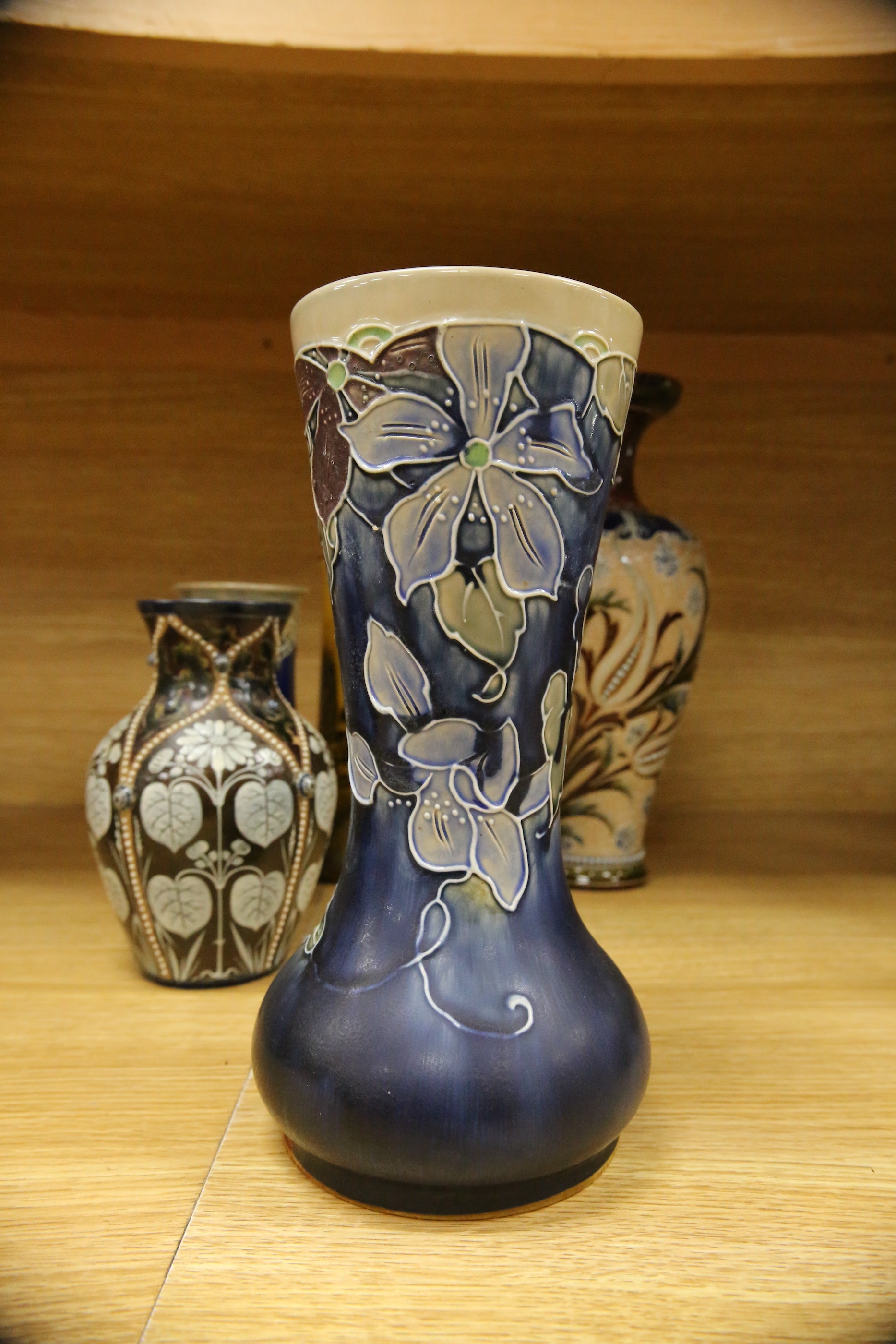 Four Royal Doulton vases and a yellow glazed jug items, tallest vase 34cm high. Condition - some crazing and faults, large vase has damage to lower neck